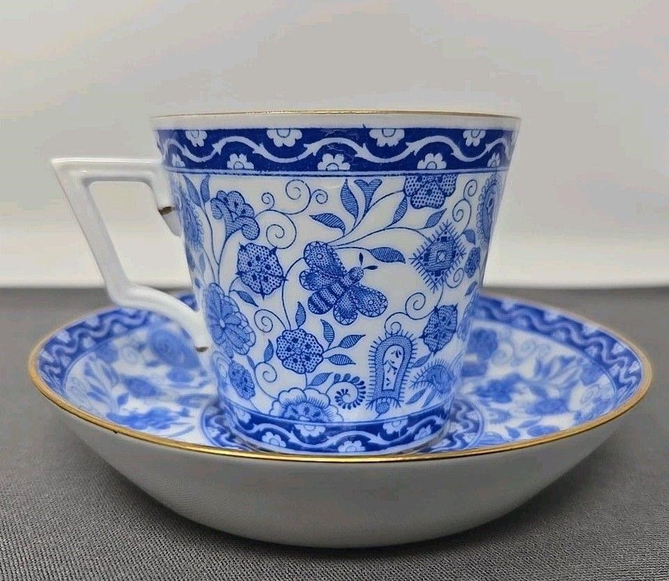 Royal Crown Derby WILMOT Demitasse Cup & Saucer: Royal Crown Derby Wilmot pattern demitasse cup and saucer set. Blue flowers and butterflies on white with gold trim. No chips, cracks, or scratches. Approximate measurements: The saucer is 4 3/8 inche