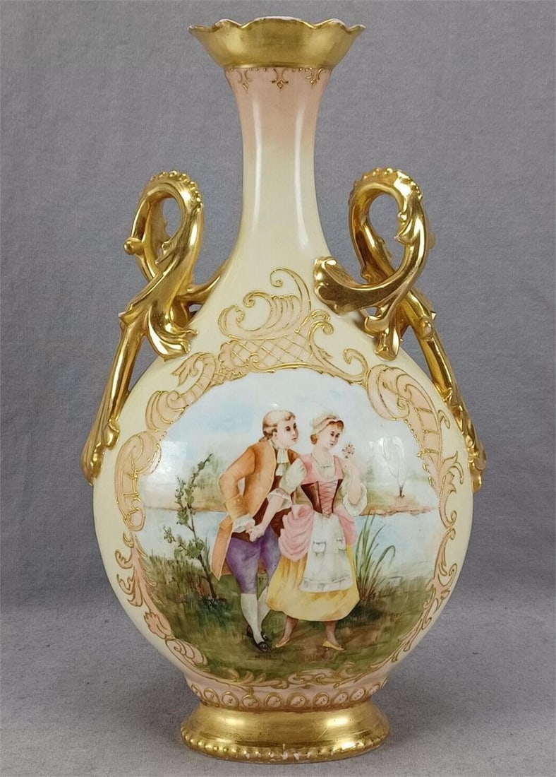 Latrille Limoges Hand Painted Watteau Scene Vase: Nice antique French porcelain vase with Rococo Revival scrollwork handles. Has a painted painted Watteau / courting couple scene framed peach and raised gold scrollwork and small gold beads. Has a yel