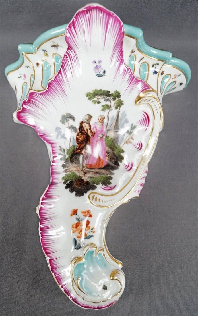 Meissen Watteau Scene & Castle Rococo Wall Shelf: Large porcelain relief molded Rococo scroll wall bracket / wall shelf. Decorated with a hand painted Georgian / Colonial courting couple of a woman in a pink gown with red underskirt and white neck