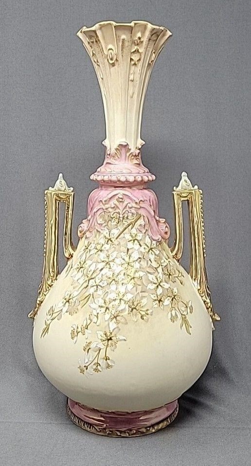 Antique Robert Hanke Large Floral Vase: Robert Hanke Vase from Austria. Circa 1890. Enameled white flowers on porcelain with raised gold . Molded handles and decorative accents. Pink on cream. No chips or cracks. Measures approximately 13 i