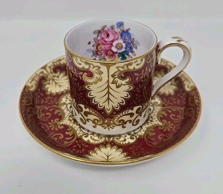 Crown Staffordshire Demitasse Cup & Saucer: Crown Staffordshire demitasse cup and saucer set. Pattern A 14188 floral bouquet center with gold and burgundy scrollwork. Post 1930. Approximate measurements: The saucer is 4 3/4 inches in diameter,