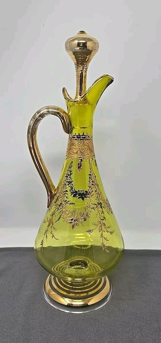 Bohemian Chartreuse Footed Handled Wine Decanter: Crystal Footed Handled Wine Decanter Late 1800s. Very nice condition, a chip on inside part of stopper as shown. Measures 10 3/8 inches in height and about 3 3/4 inch at the widest part. The base is a