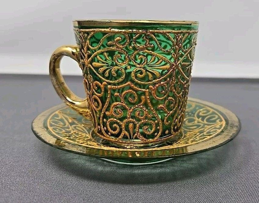 Bohemian Glass Demitasse Cup & Saucer Teal Gold: Bohemian glass demitasse cup and saucer set. Teal and peach and gold enamel Moser style. Late 1800s. Cup measures 2.1/4 high and 2 1/4 diameter. Saucer measures 3 3/4 inch diameter. No chips or damage