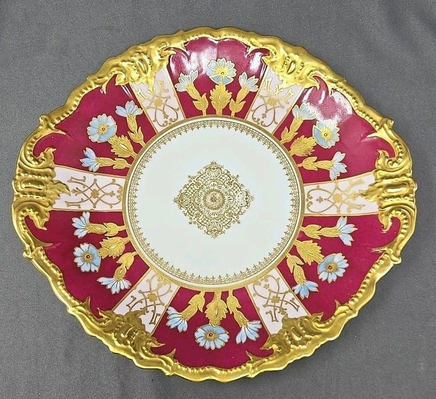 Blakeman Henderson Limoges Blue Floral Cake Plate: Blakeman & Henderson Limoges handled plate. Heavy gold on marron with blue flowers and pink accents. No chips, cracks or scratches. Some light loss of gold on edge. Measures approximately 11 1/4 inche