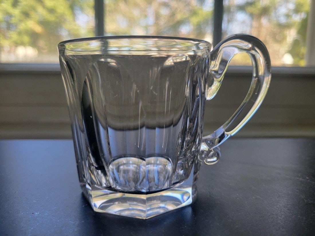 Flint Glass Whiskey Taster 1850'S 2 3/4": Nice condition flint glass Whiskey Taster with applied handle. Circa 1850s. The sides are cut and polished and has a polished pontil. There is some extra glass next to handle base. Please see pictures