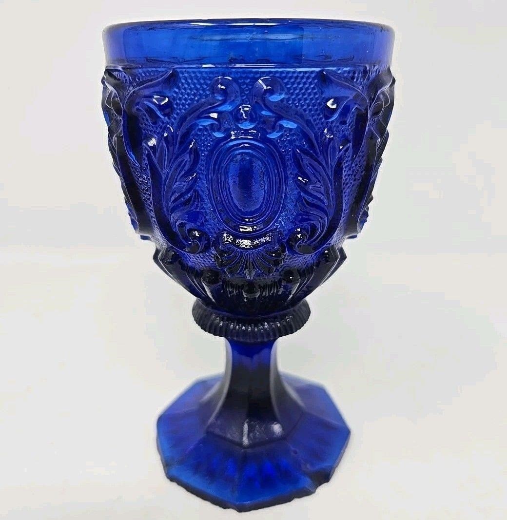 St Louis Cobalt Blue Pressed Glass Wine Glass: Attributed to St Louis or Baccarat cobalt blue pressed glass wine. Measures approximately 4 3/4 inches tall, and the top diameter is 2 1/8 inches diameter. It has a large chip and a number of smaller