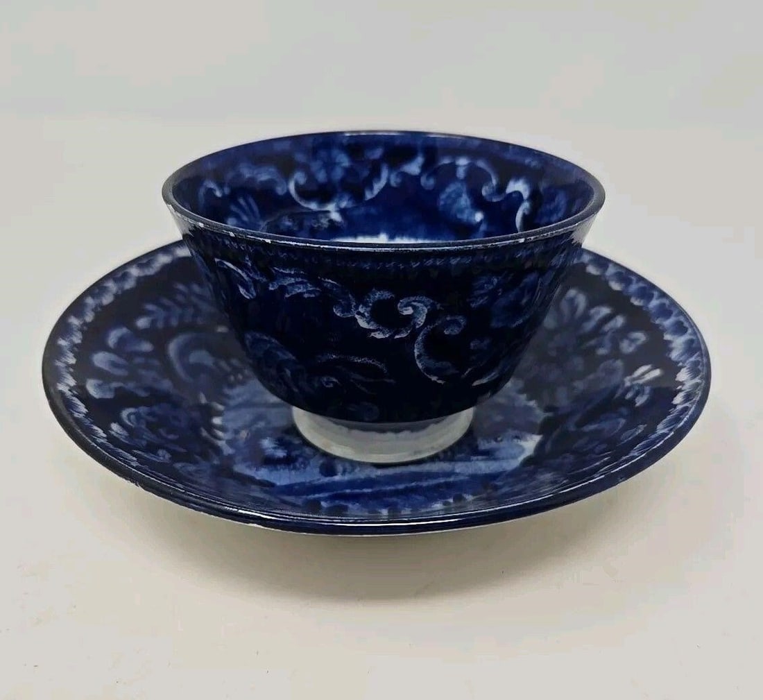 Baker Bevans & Irwin Shepherd Ptrn. Cup & Saucer: Baker, Bevans, & Irwin earthenware handle-less teacup and saucer set in Shepherd pattern #6631. Unmarked. Circa 1814 to 1838. M3 approximately: saucer 5 7/8 inches diameter and 1 1/4 inches tall. The