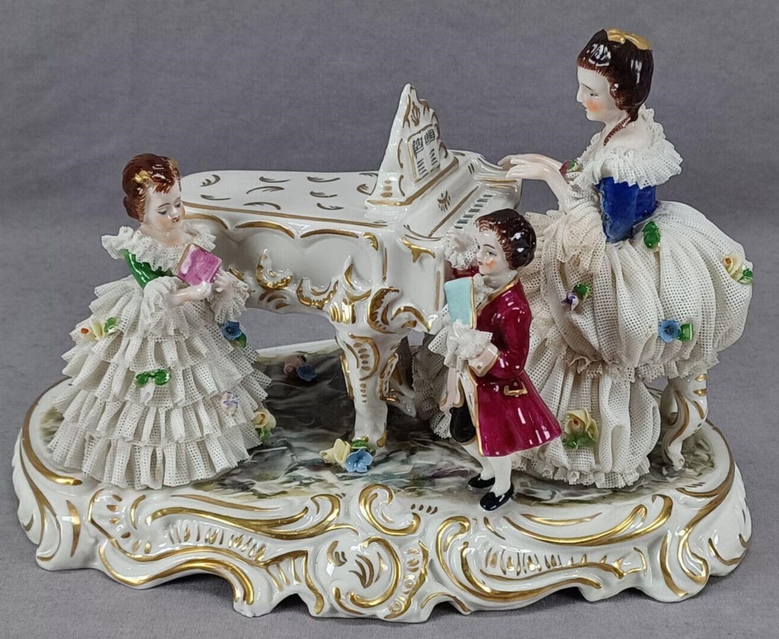 Volkstedt Dresden Lace Figural Group With Piano: Nice vintage hand painted porcelain figural group in the "Dresden Lace" style. With a woman playing the piano, and a little boy and girl with books of music. Gold scrollwork gilding. Marked on the bot