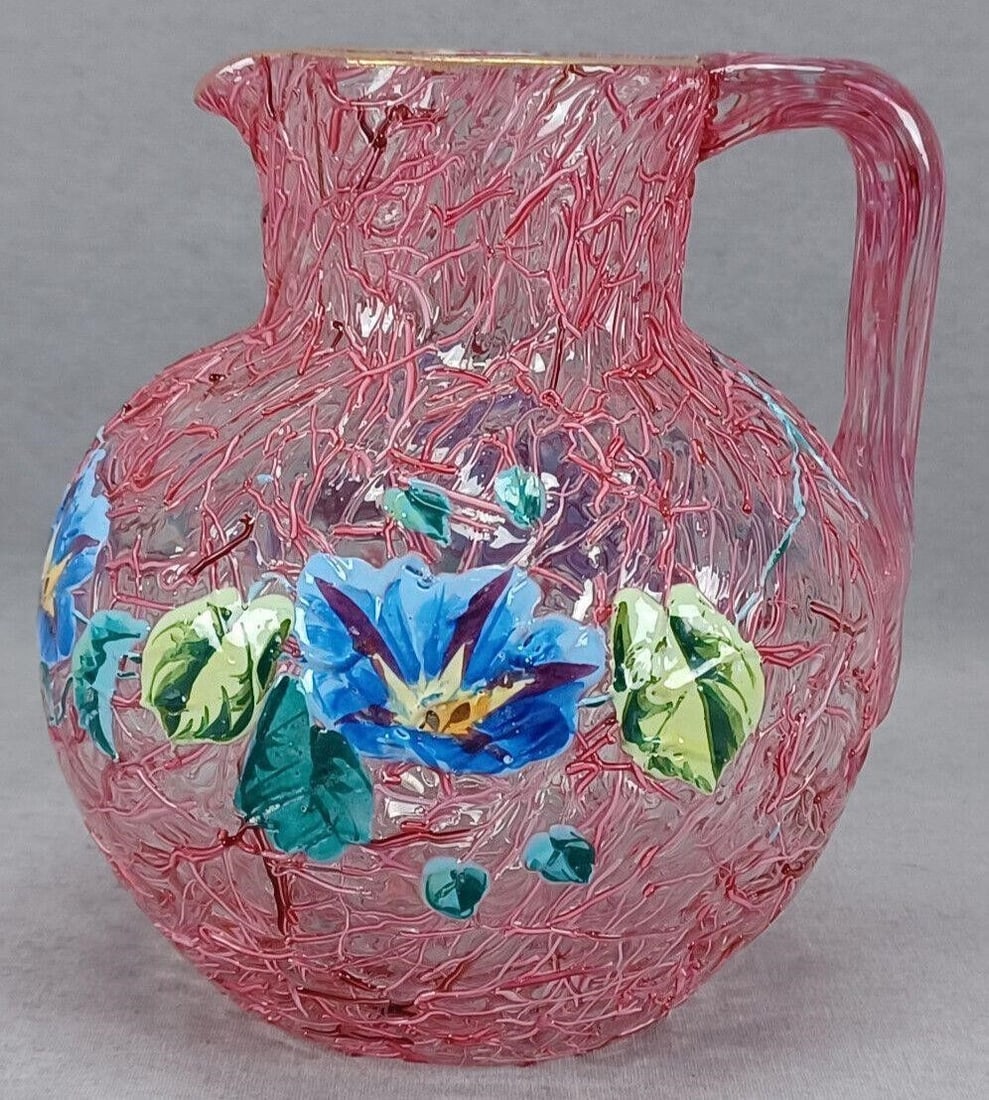 Harrach Morning Glories Pelotan Glass Pitcher: Antique late 19th century Bohemian Harrach clear glass pitcher with pink pelotan decoration and hand enameled blue morning glories. Gold gilding along the rim. Ground and polished pontiled base.Has so
