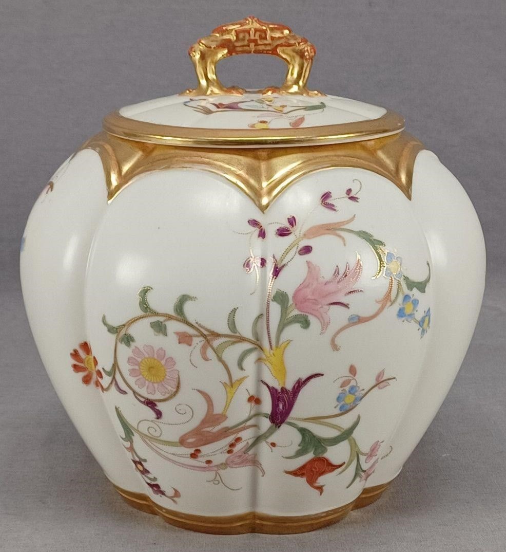 Royal Worcester Floral Scrollwork Biscuit Jar: Nice antique porcelain biscuit jar. Decorated with hand painted flowers and scrollwork in pink, purple, yellow, blue, and orange with gold highlights over an ivory background. Gold gilding along the