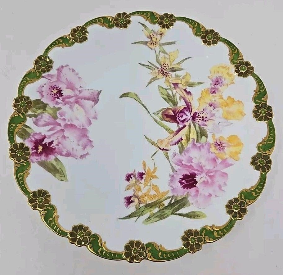 Tressemann & Vogt Limoges Orchid Plate 9 1/4": Tressemann & Vogt LIMOGES factory decorated with hand painted orchids and a pattern molded floral edge. Circa 1907. Measures 9 1/4 inches diameter and 1 inches tall. No chips or cracks. There are some