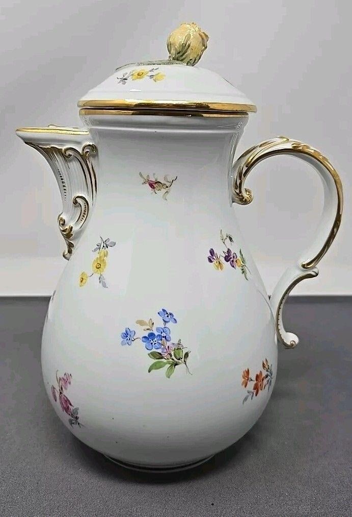 Meissen Floral Decorated Coffee Pot 9": Meissen floral decorated coffee pot. Measures approximately 9 inches tall and 6 1/2 inch from spout to handle. No chips or cracks on the pot. The lid has some damage to a couple of petals on the finia