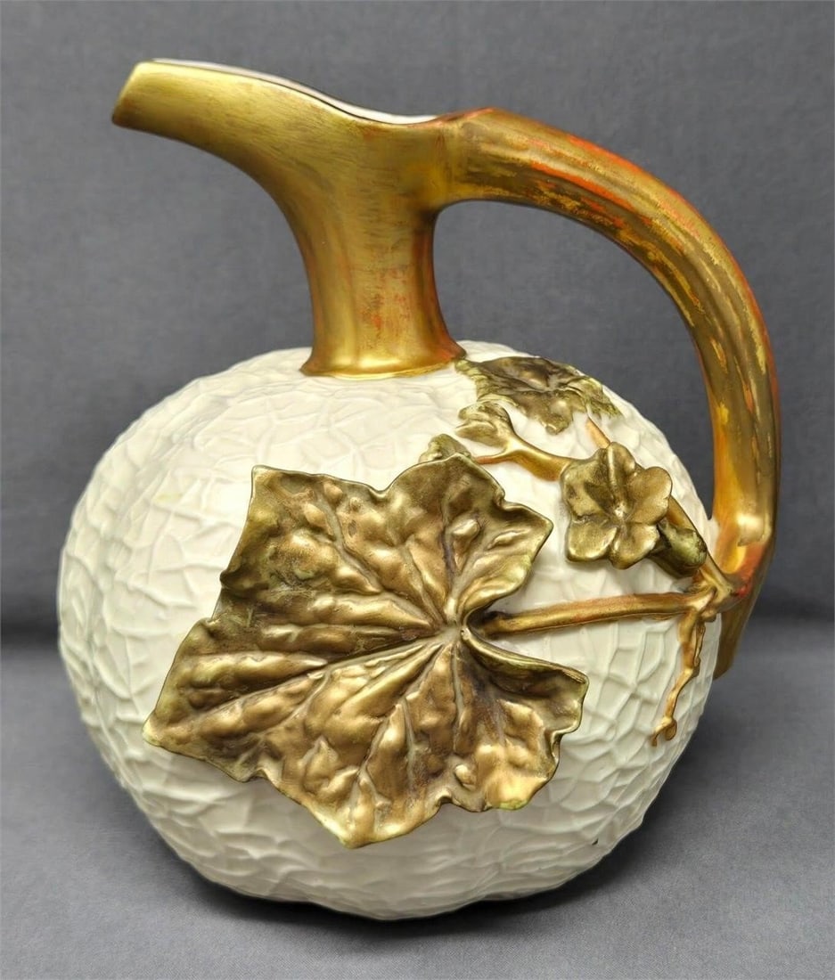Royal Worcester Cantaloupe Shaped Ewer: Royal Worcester ewer / pitcher shaped like a cantaloupe with vines and leaves that form the handle and decoration. The form number is printed on the bottom and impressed. The registry number is 35785