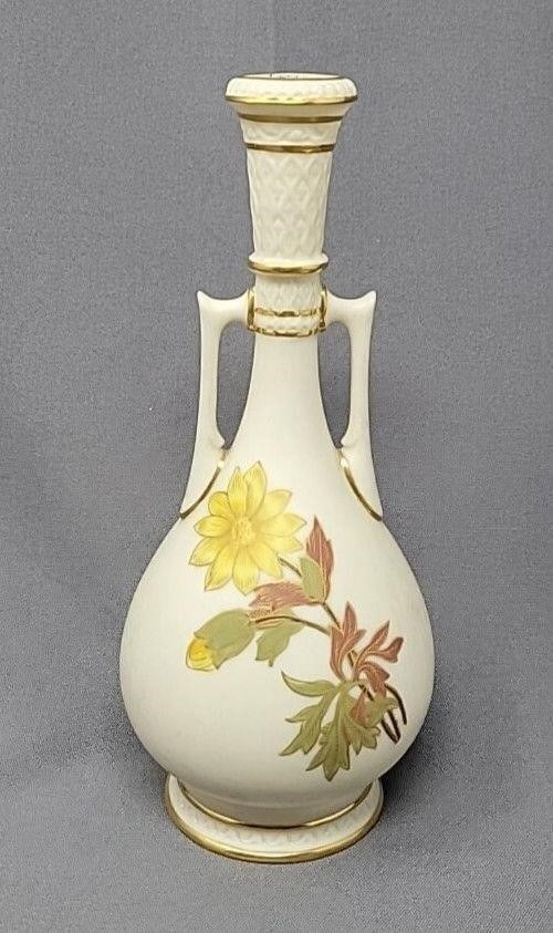 Royal Worcester Blush Ivory & Gilt Floral Vase: Royal Worcester Blush Ivory floral long neck bud vase. There are yellow flowers on one side and pink on the other. Two molded handles with decorative accents on base and top. No chips or cracks, there