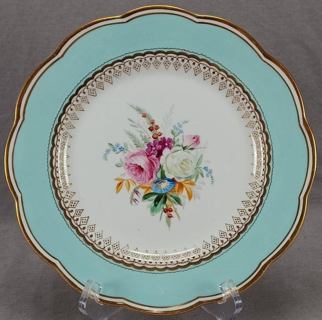 Davenport Hand Painted Floral Aqua & Gold Plate: Nice antique mid 19th century British porcelain plate. Decorated with a floral bouquet of pink and white roses with purple and blue flowers and red berries. Has an aqua border with gold gilt scalloped