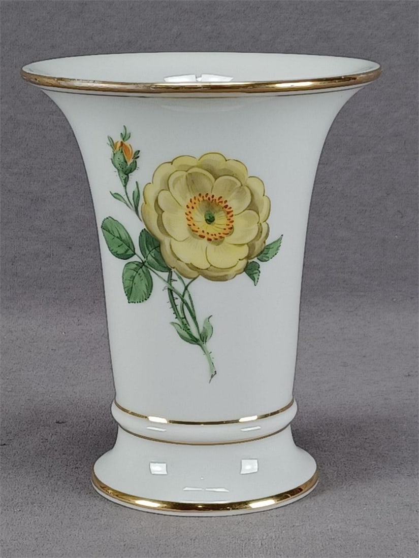 Meissen Yellow Rose 5 1/2 Inch Vase C. 1860-1924: Nice antique German porcelain vase. Decorated with a large hand painted yellow rose and small yellow rose bud on the front with additional small blue and pink flowers on the back. Gold gilding along t
