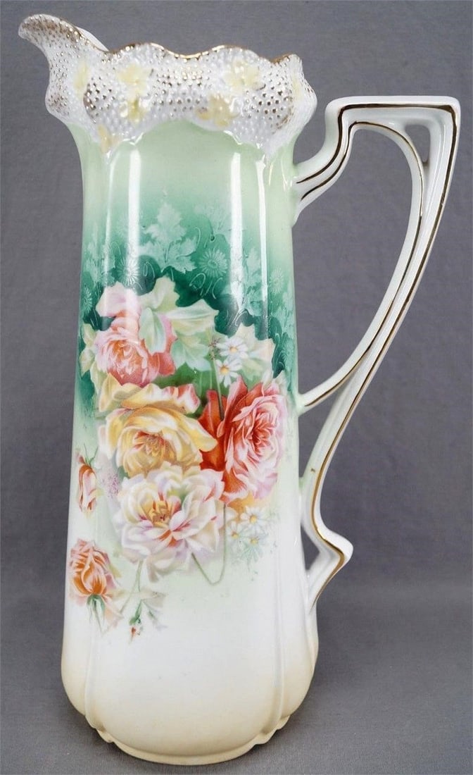 RS Prussia Mold 525 Roses Green Gold Large Tankard: Beautiful relief molded porcelain tankard in Mold 525. Decorated with large pink, yellow and white roses and small white daisies over a green background with white shadow flowers. With gold gilt highl