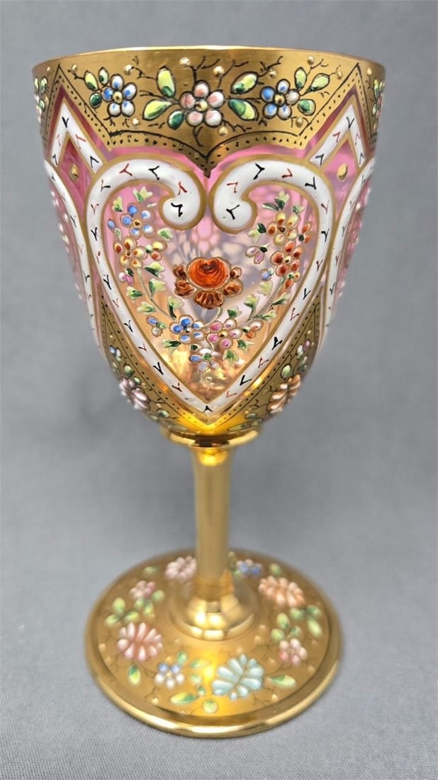 Harrach Gold Gilt and Enamel Wine Glass: Antique Harrach wine glass with gold gilt and enamel. The pattern number is 377-50 with white enamel hearts on a light cranberry that fades to clear glass with gold gilt on background, stem and base a