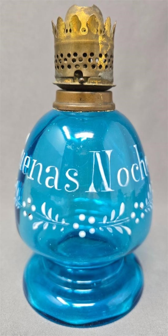 Bohemian Blue Glass Enameled Oil Lamp: Bohemian enameled decorated blue glass oil lamp Buenas Noches. Burner is P & A MFG Co, Plume and Atwood. Circa 1900. Measures approximately 6 inches tall and 3 inches wide. The sides are optic molded.