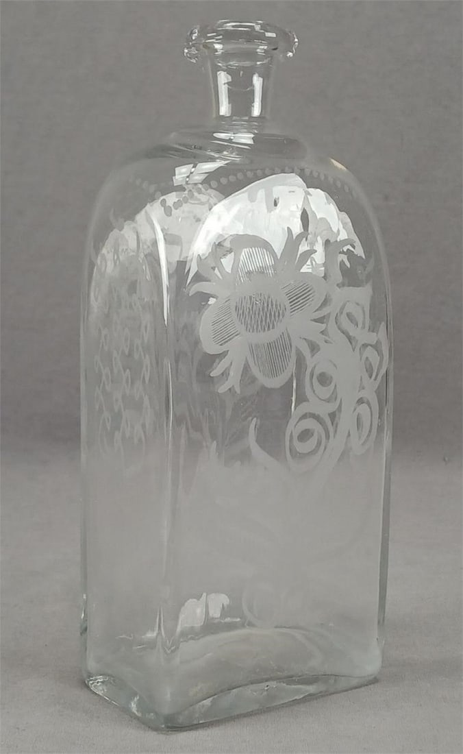 Antique Engraved Floral Glass 8 3/4" Case Bottle: Antique late 18th / early 19th century continental clear blown flint glass cast bottle. Engraved floral designs. Rough pontiled base. Has some haze to the interior, but otherwise good condition. Measu