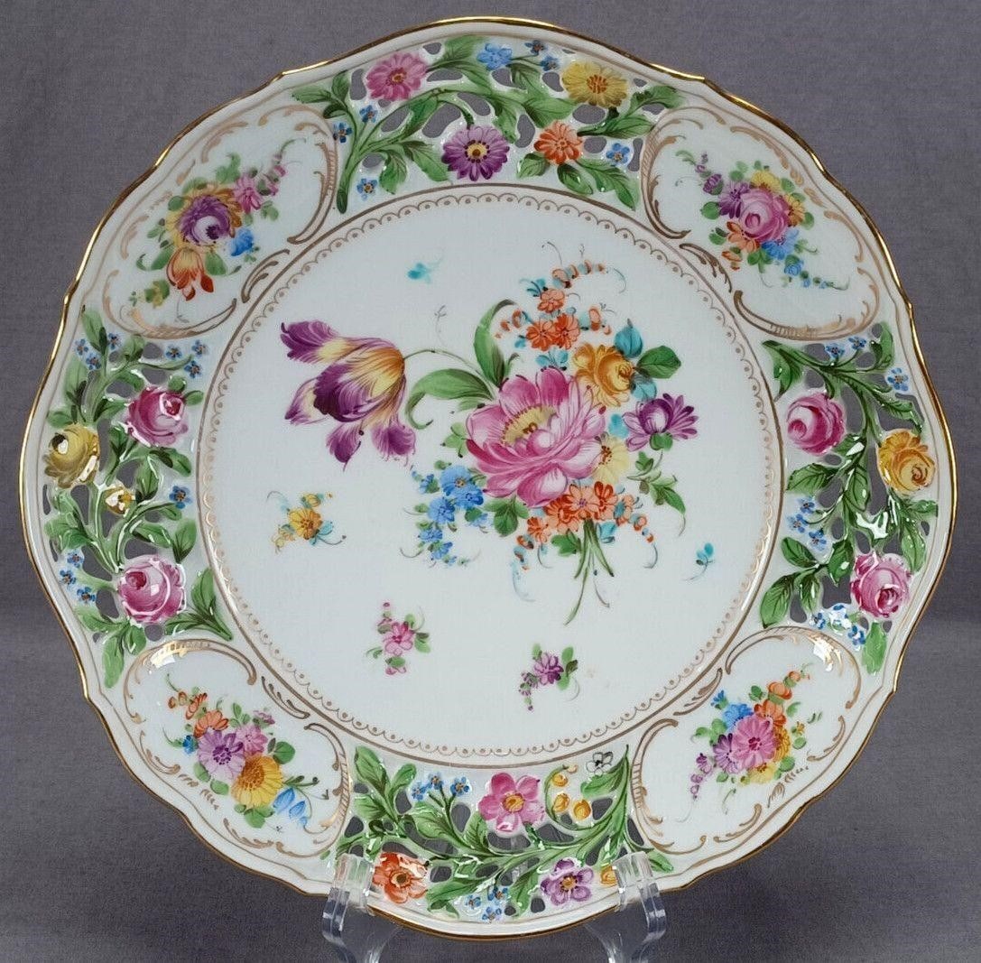Dresden Floral Reticulated 10 1/4" Shallow Bowl: Nice antique German reticulated shallow porcelain bowl. Decorated with hand painted flowers in pink, purple, blue, orange, and yellow. With gold scallops and dots along the inner rim. Hand painted flo