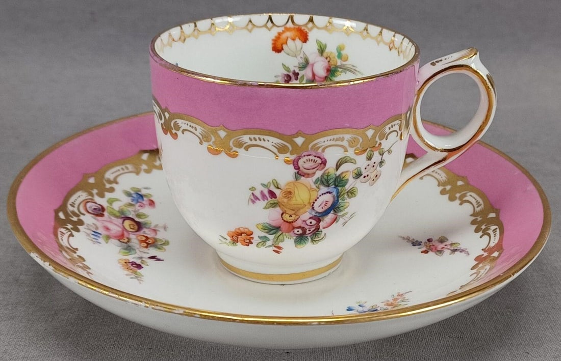 Coalport Floral Pink Coffee Cup & Saucer C.1860s F: Nice bone china ring handle coffee cup and saucer. Decorated with hand painted pink roses and other flowers in pink, purple, blue, yellow, and orange. Has a pompadour pink border with gold scrollwork 