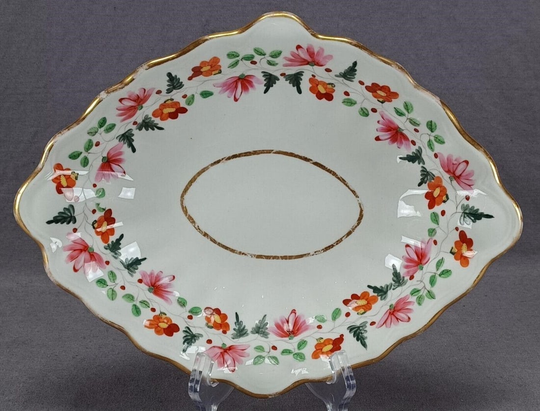 Derby Floral & Gold Dessert Dish C 1806-1825: Nice antique British bone china dessert dish. Decorated with hand painted pink and orange flowers. Gold highlights to the handle and gold gilding along the edge. Marked on the bottom with the red Derb
