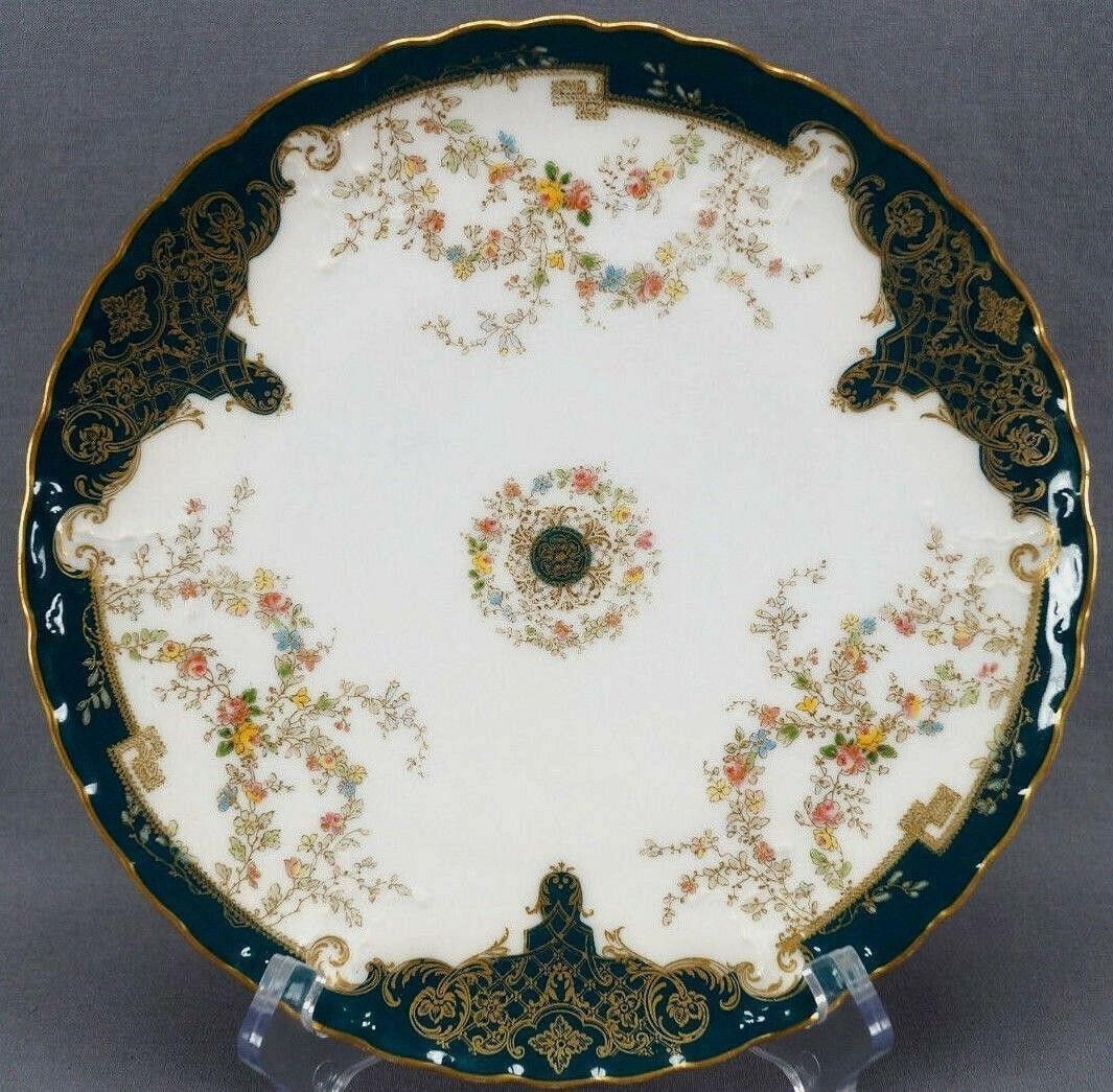Haviland Limoges Blue Green Gold 9" Antique Plate: Antique molded porcelain plate on the Portia blank #12. Nicely decorated with hand painted garlands made up of pink and yellow roses and blue, yellow, and pink small flowers with gold gilt outlines. W