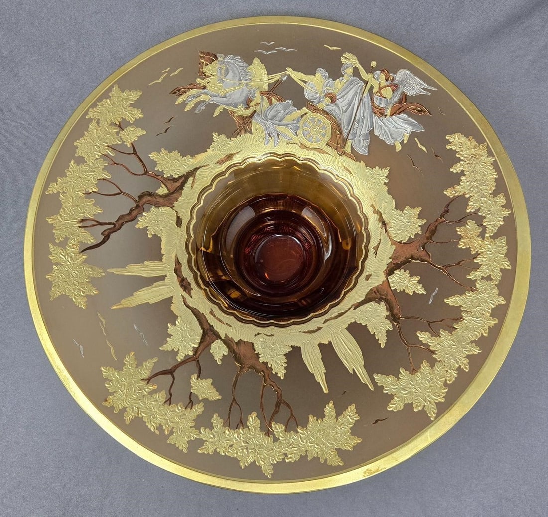 Bohemian Amber Haida Glass Bowl Signed: Bohemian signed Wolfgang Berndt Haida glass centerpiece bowl. Amber glass with raised gold and platinum design with a horse drawn chariot, 2 drivers followed by an angel with trees and birds on a fros