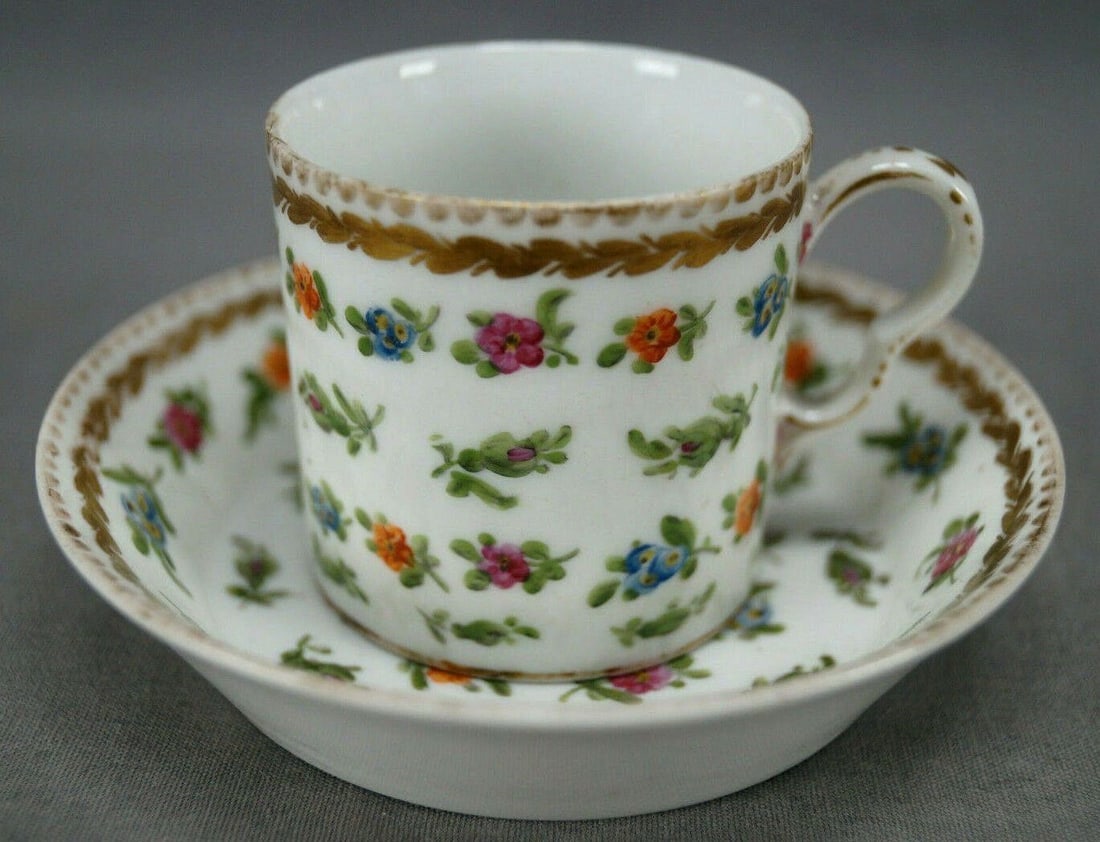 La Courtille Demitasse Cup & Saucer C1773-1824: Nice late 18th / early 19th century French porcelain demitasse cup and saucer. Decorated with hand painted small flowers in pink, blue and orange. With gold laurel leaves and gold scalllops along the 