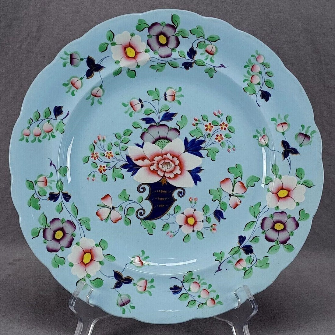 Ridgway Pattern 44 Floral Blue Stoneware Plate: Antique British blue earthenware / blue stoneware plate in the Albion shape. Decorated with hand colored pink, purple, white, and orange flowers with green and cobalt leaves with gold highlights. Mark