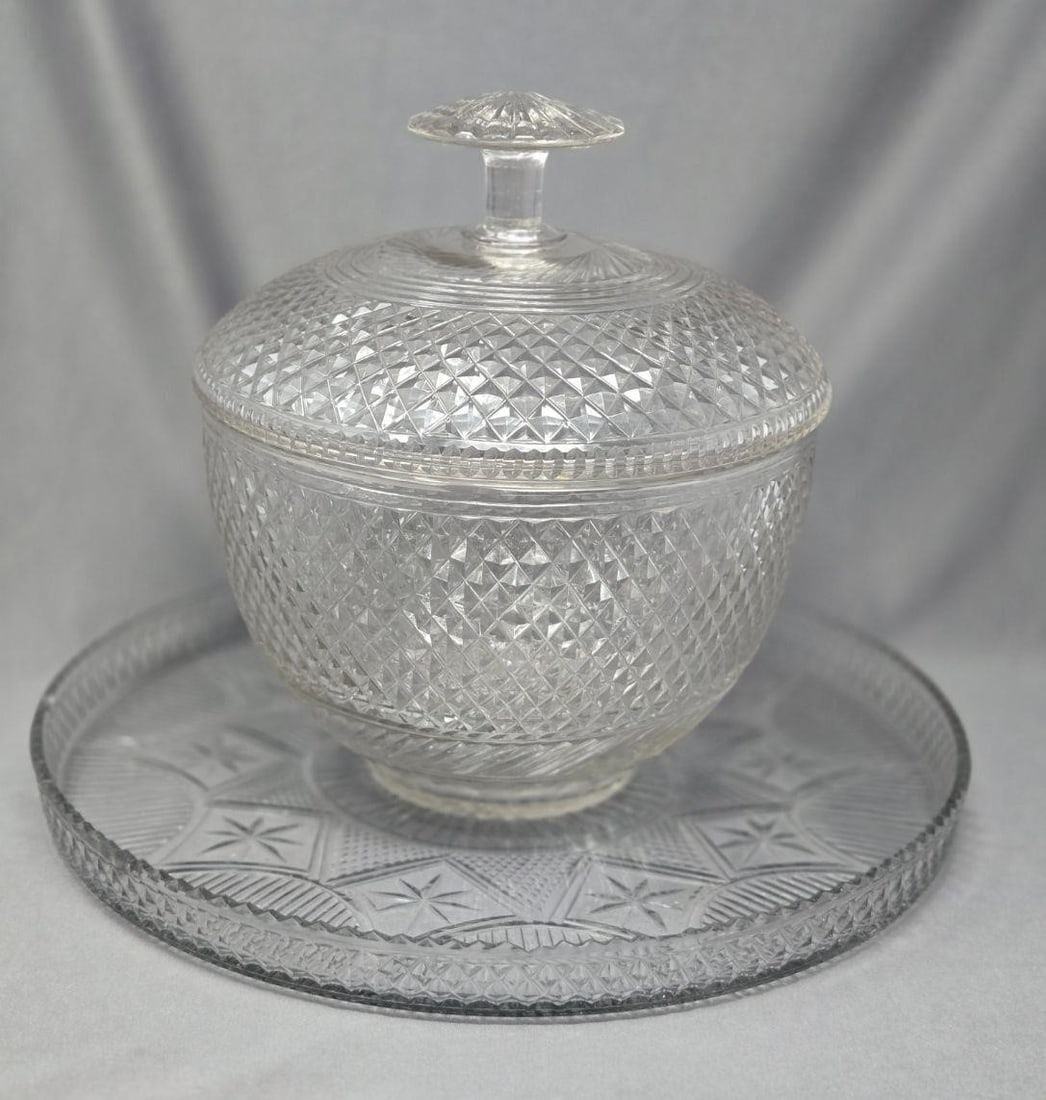 Anglo Irish Punch Bowl Set C. 1790 -1810: Antique Anglo Irish cut punch bowl, lid and undertray. circa 1790 to 1810. Diamond and lined pattern with the tray having a starburst pattern with smaller star cuts at each point and diamond cuts on