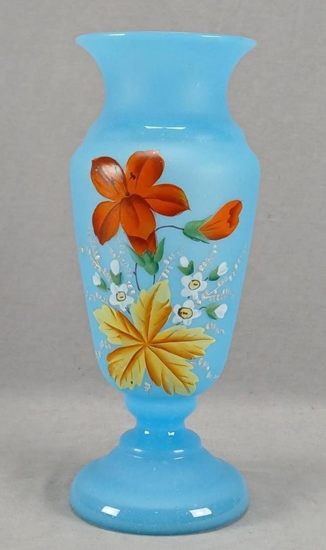 Bohemian Enameled Lily Blue Glass 10 7/8" Vase: Antique Victorian era late 19th century Bohemian blown blue alabaster glass vase. Decorated with a hand enameled red lily flower and white flowers and a large yellow leaf. With gold highlights to some