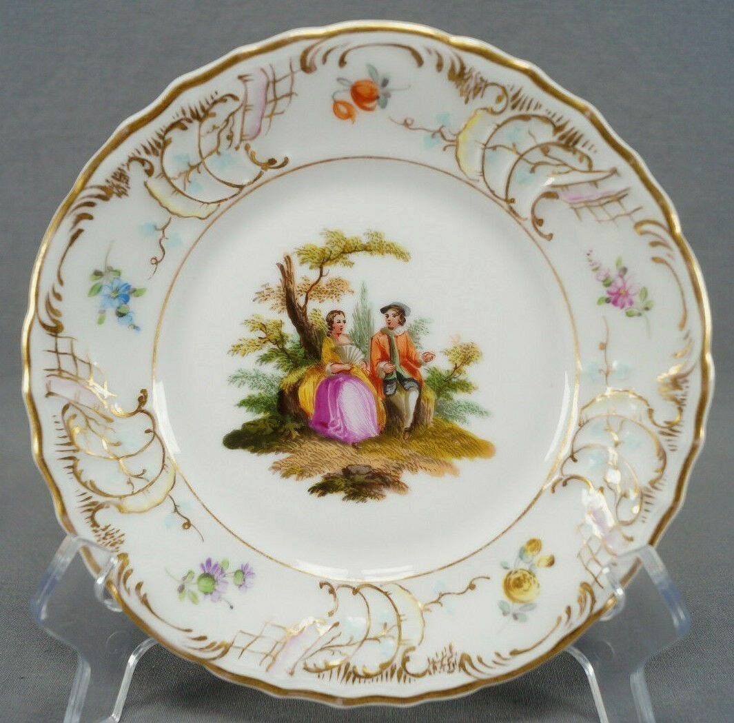 Dresden Watteau Scene Floral Gold Bread Plate A: Beautiful porcelain bread plate with relief molded scrollwork border. Decorated with a hand painted courting couple and trees in the center. The border has gold gilt highlights to the relief molding,