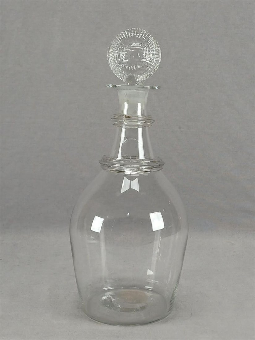 British Flint Glass 10 3/4" Decanter Circa 1820: Antique 19th century British blown flint glass decanter. Applied neck rings. Rough pontiled base. Pressed wafer stopper. Circa 1820.Has some haze to the interior of the decanter along the bottom, but 