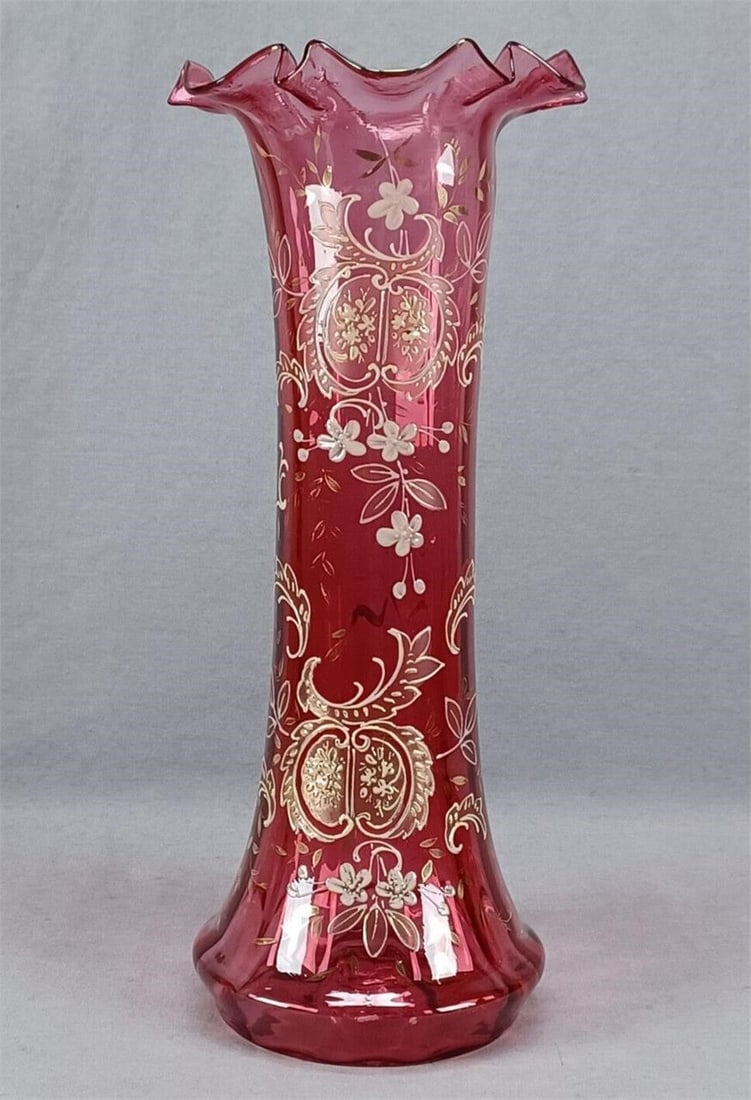 19th Century Bohemian Floral Cranberry Vase: Antique late 19th century Victorian era Bohemian blown optic molded cranberry glass vase. With raised cream colored enamel and gold floral scrollwork designs. Gold gilding along the rim. Rough pontile