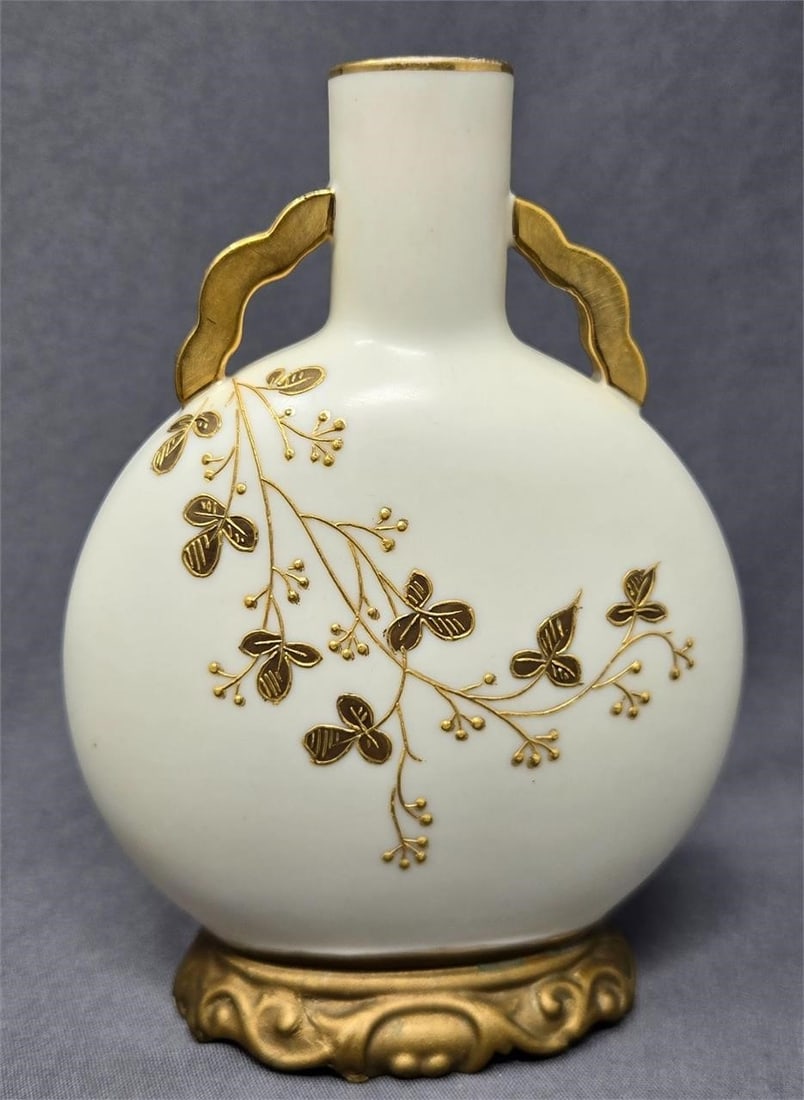Royal Worcester Small Vase c. 1886 Repaired: Royal Worcester small vase with raised gold floral pattern on both sides. Date code X is 1886. Measures approximately 5 inches tall and 4 inches wide and 2 inches narrow end. It has been repaired, the