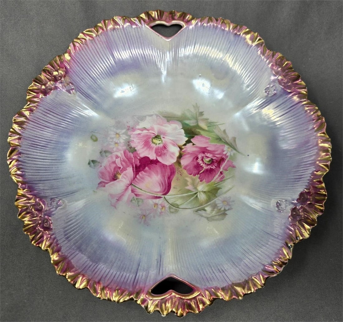 RS Prussia Luster Border with Poppies Mold 211A: RS Prussia mold 211A handled bowl. It has a purple luster border with a gold over purple edge and pink poppies in the center. It is in nice condition with some rubs likely from stacking, but no chips 