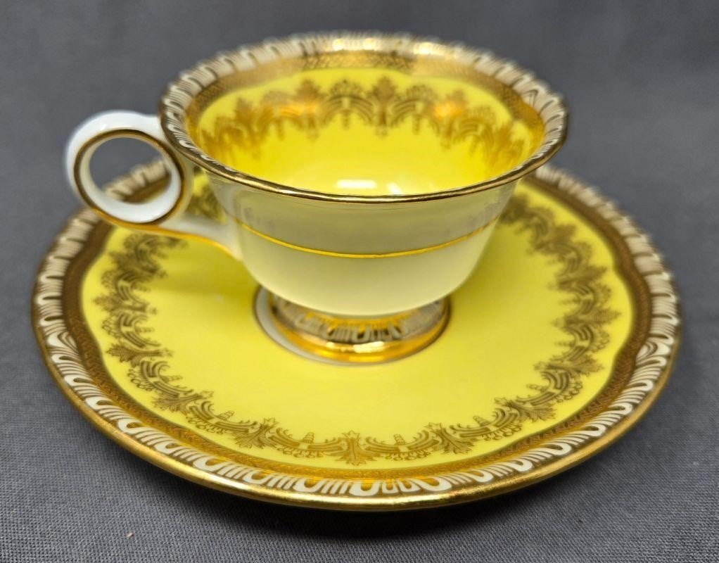 Yellow Cauldon Demitasse Cup and Saucer: Cauldon footed demitasse cup and saucer set in yellow and gold. Marked 888 for pattern, but might be missing a number. Circa 1891 to 1920. Good condition with some minor scratches, but no chips or cra