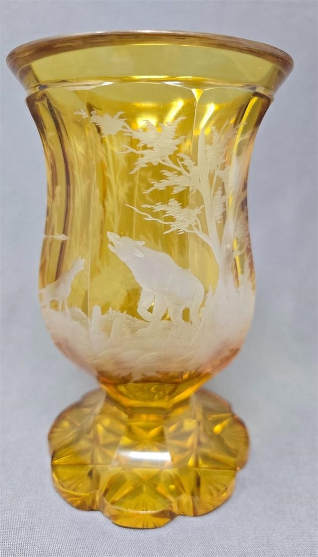 Bohemian Engraved Goblet Bear Hunting Scene: 19th century Bohemian amber with engraving to clear glass goblet. It has a very fine detailed engraving of a forest scene, a hunter and a dog facing a bear. The stem is and 8 sided petal cut with a