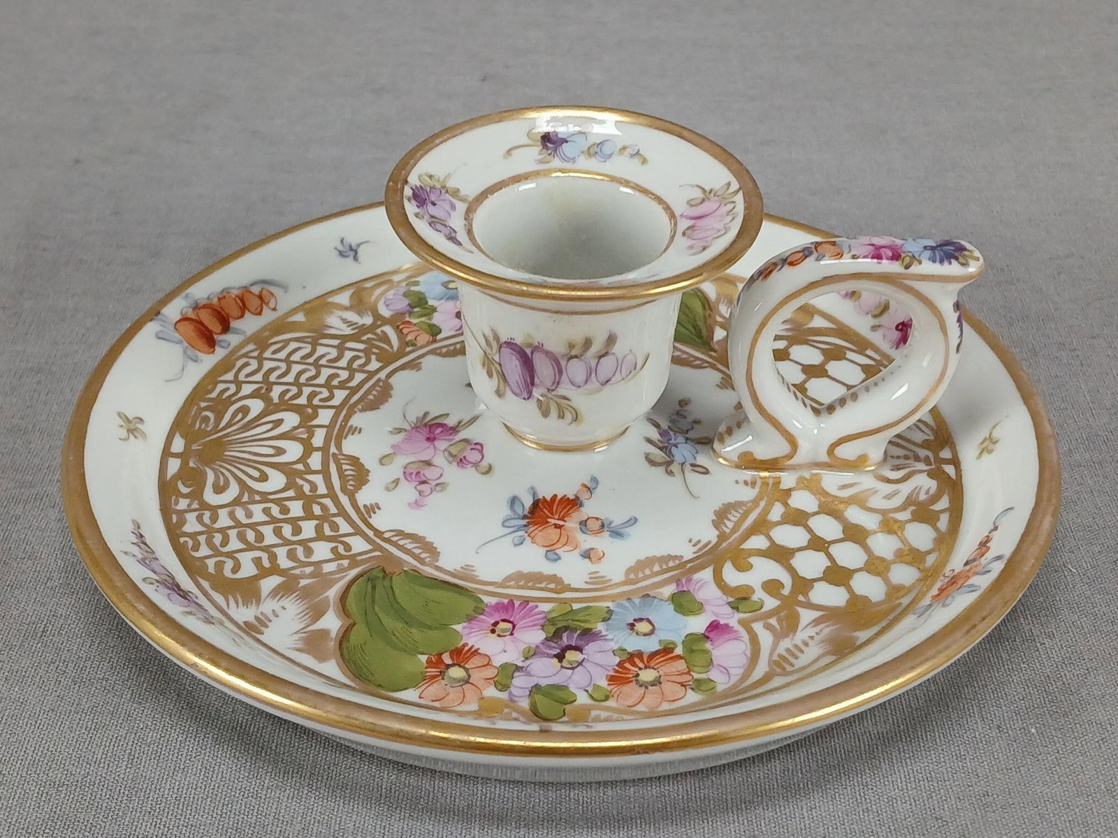 Dresden Hand Painted Floral & Gold Chamber Stick: Antique German porcelain chamber stick. Decorated with hand painted flowers in purple, pink, blue, and orange and gold lattice and floral designs. Gold gilding along the edge. Marked on the bottom wit