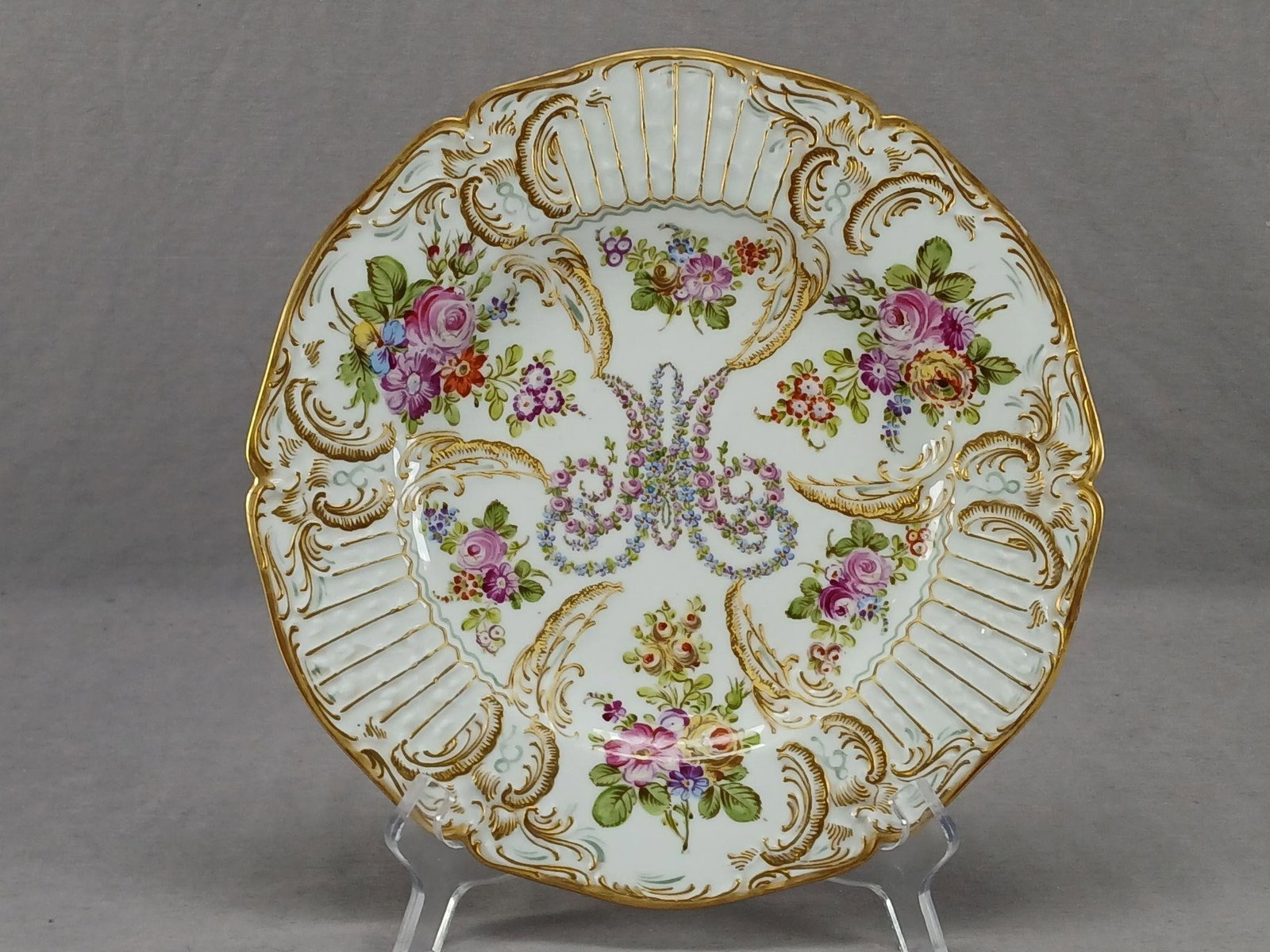 Leboeuf Hand Painted Marie Antoinette Plate A: Nice porcelain dinner plate with relief molded floral and scrollwork designs with raised gold gilt and aqua highlights. Decorated with a pink rose and blue forget me not Marie Antoinette monogram in t
