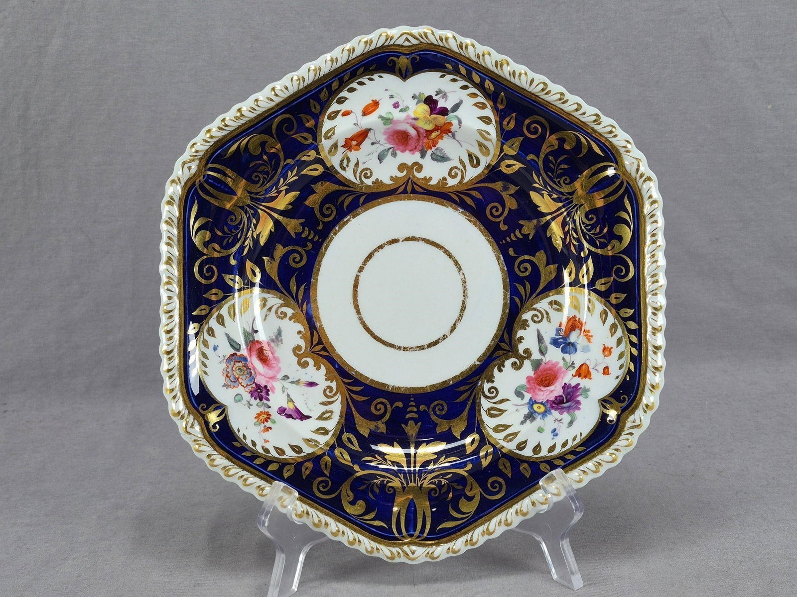 Ridgway Floral Cobalt & Gold 10 Inch Plate A: Antique British bone china six sided plate. Decorated with hand painted pink, blue, purple, orange and yellow flowers over white framed in gold scrollwork and leaf gilding. Has a wide cobalt blue bord