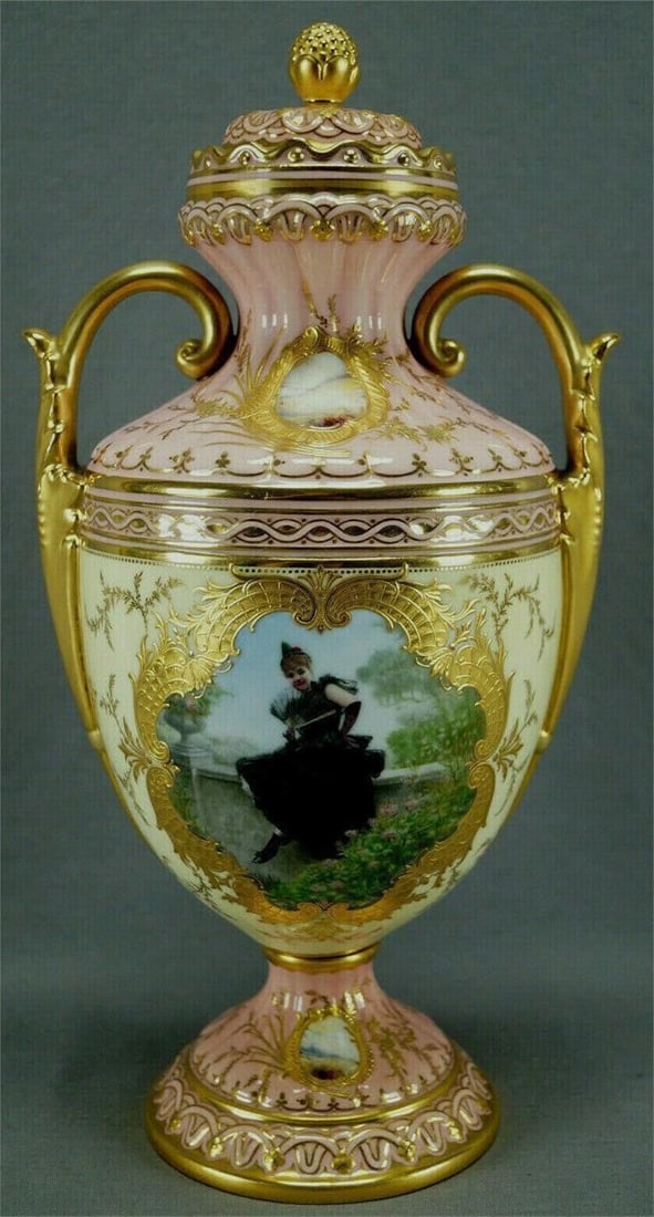 Coalport Hand Painted Girl In Black Dress Pink Urn: Fabulous porcelain bone china urn or covered vase. The center portion of the urn has a hand painted scene of a girl in a black dress holding a hand fan and sitting on a stone wall in a garden framed i