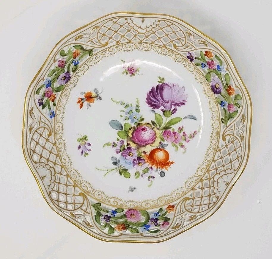 Donath Dresden Reticulated Bowl, Hand Flowers: Dresden style reticulated bowl by Donath. The bowl measures 9 inches across and is hand painted with large beautiful flowers. The flowers are purple, orange and blue with accents in gold. The foot of 