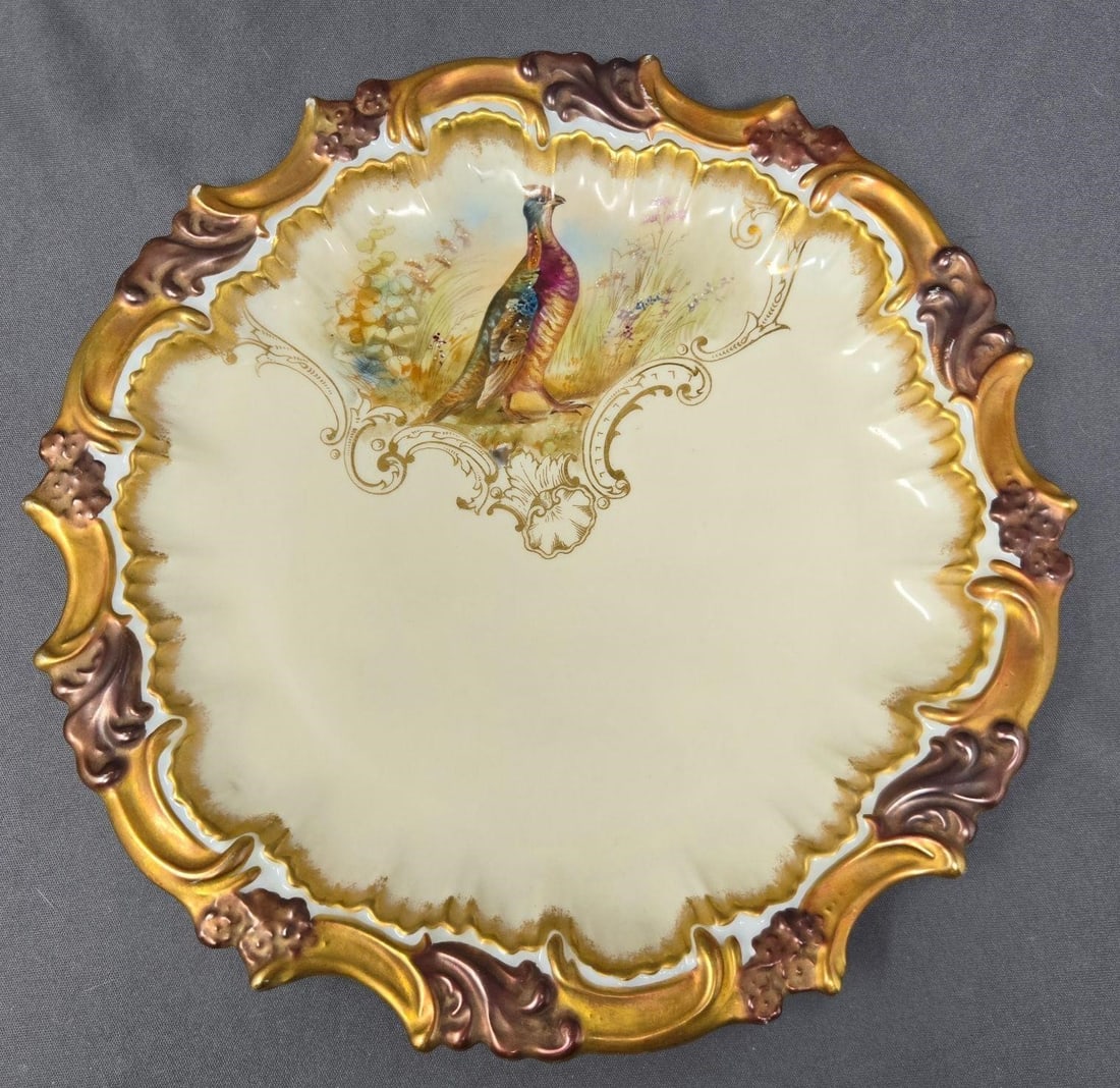 T & V Limoges Pheasant Plate 9 3/8": Tressemann and Vogt Limoges decorative plate with a pheasant and molded edges with gold. Measures approximately 9 1/2 inches in diameter. No chips or cracks there is some missing gold on high points o