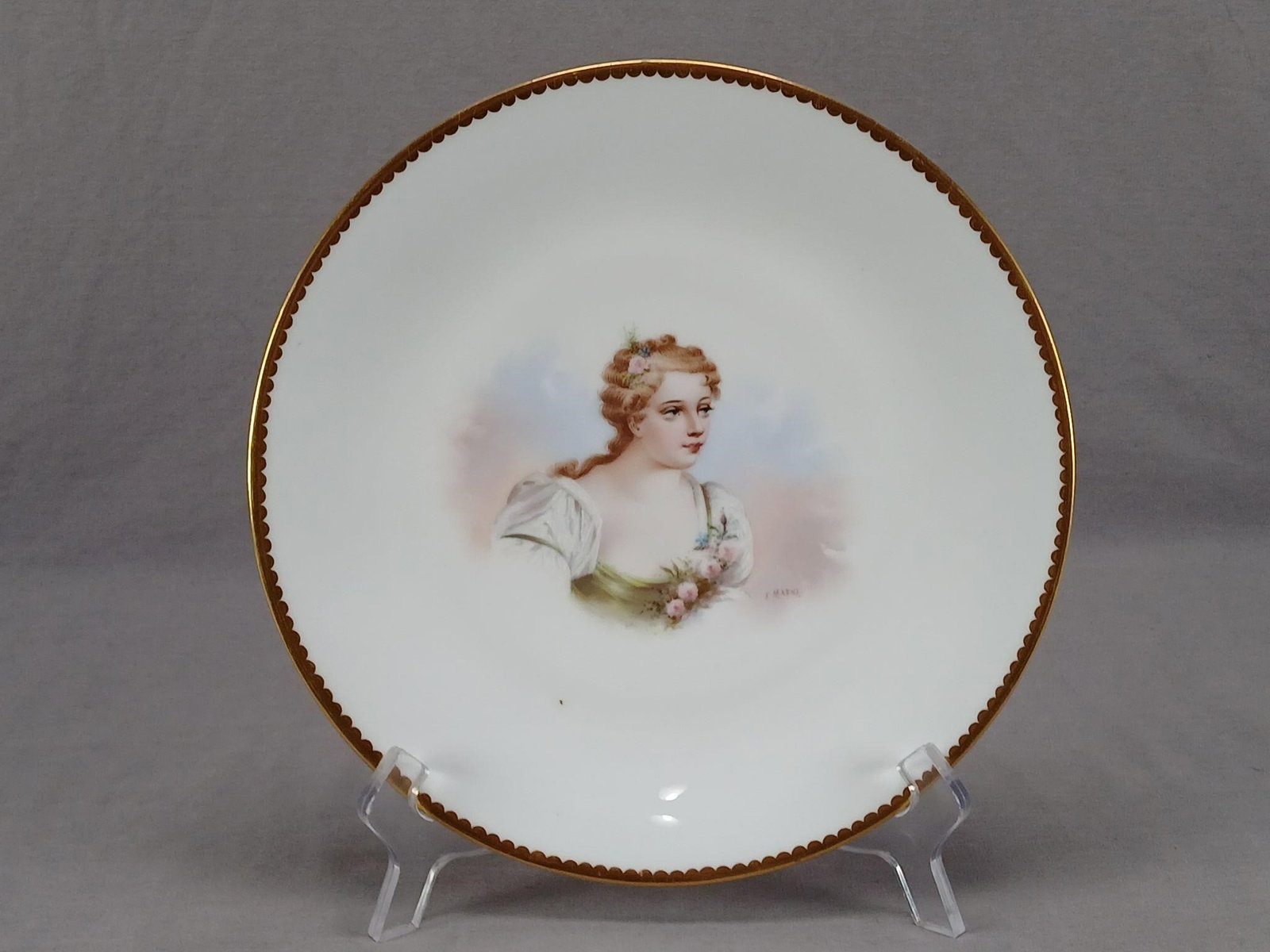 Minton Hand Painted Madame de Parabère Plate: Antique British bone china plate. Decorated with a hand painted portrait of Madame de Parabère. Signed by the artist F. Maene. Scalloped gold gilding along the edge. Impressed Mintons on the reverse 