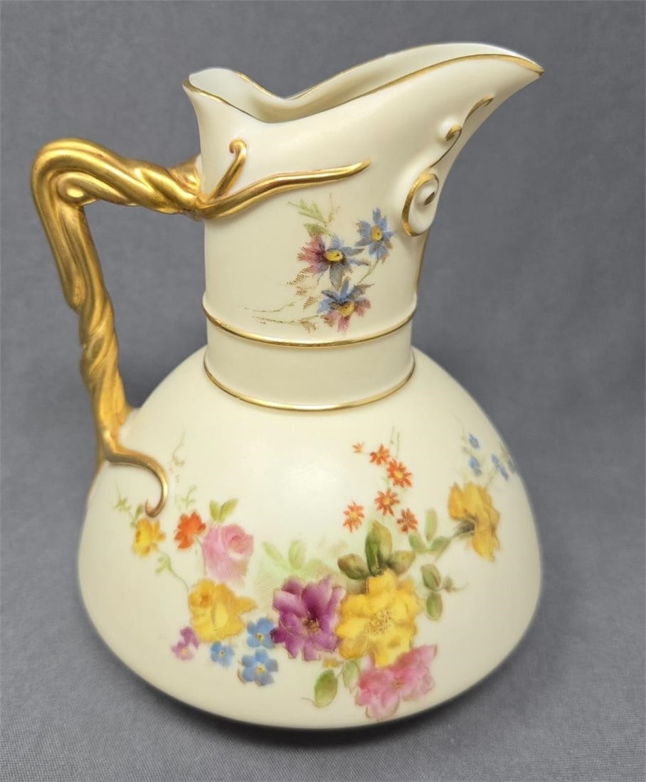 Royal Worcester Blush Ivory Milk Pitcher Form 1378: Royal Worcester milk pitcher in form # 1378. It has a vine handle with hand painted wildflowers. Measures approximately 5 1/4 inches tall and 4 1/4 inches wide. Circa 1893. No chips or cracks, there i