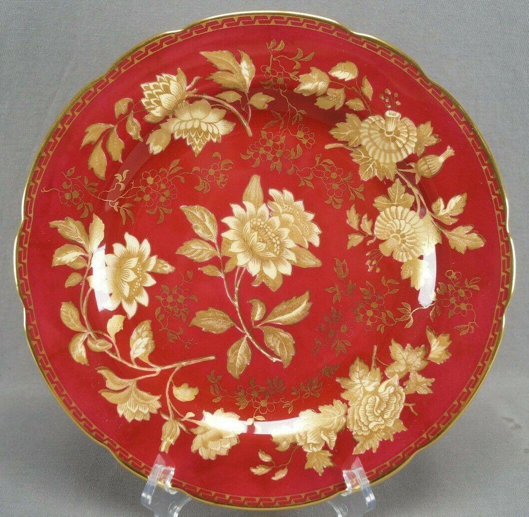 Wedgwood Tonquin Ruby 11 Inch Bone China Plate B: Nice bone china dinner plate. Decorated in the Tonquin Ruby pattern with large gold and beige flowers over a dark red background. Marked on the reverse Wedgwood Bone China Made in England.Has some wea