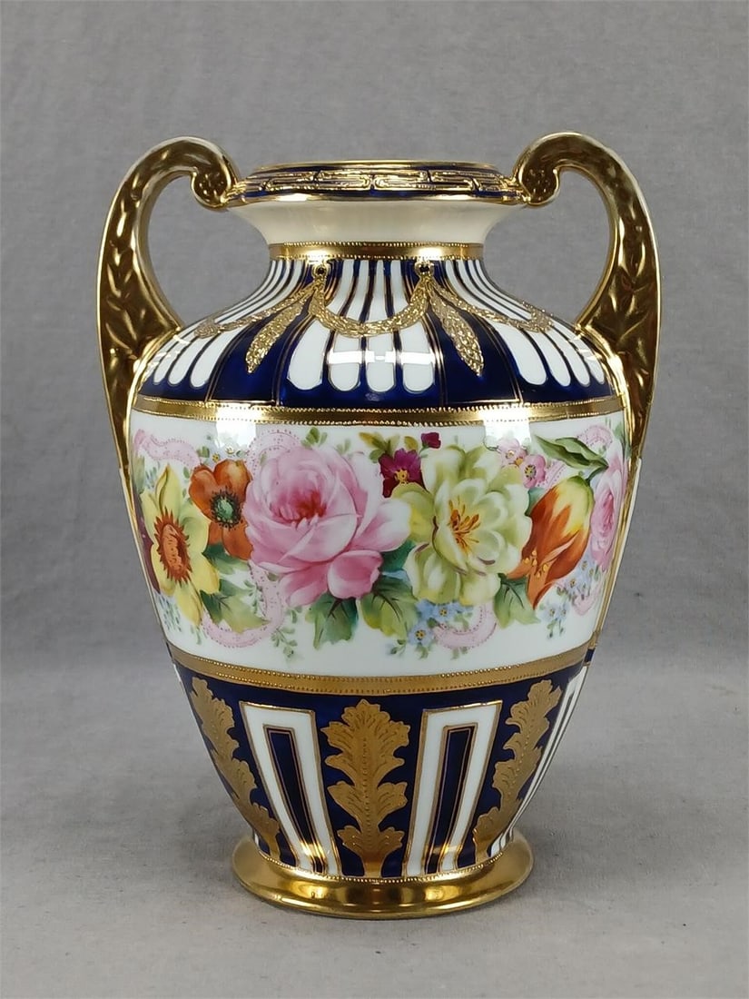 Nippon Floral Cobalt & Gold Neoclassical Vase: Antique Japanese porcelain vase. Decorated with hand painted pink roses and other flowers in orange, yellow, and dark pink with pink ribbon over a white center framed in gold bands and gold beading. W